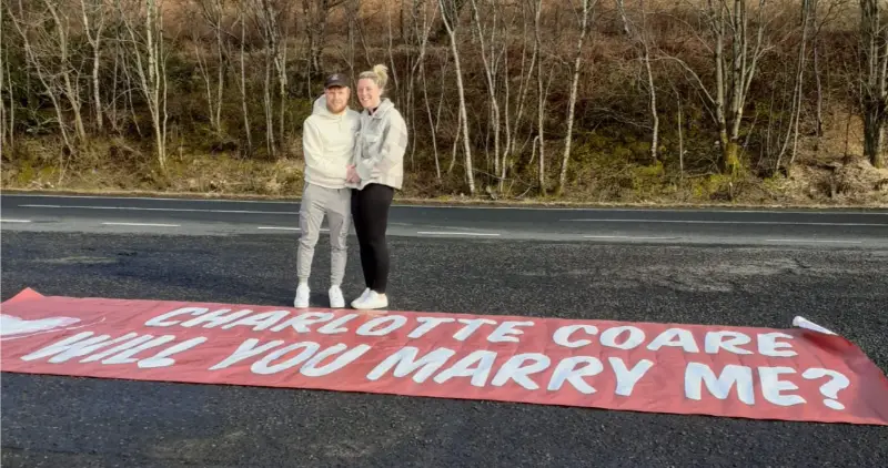Proposal banner with the lucky couple.