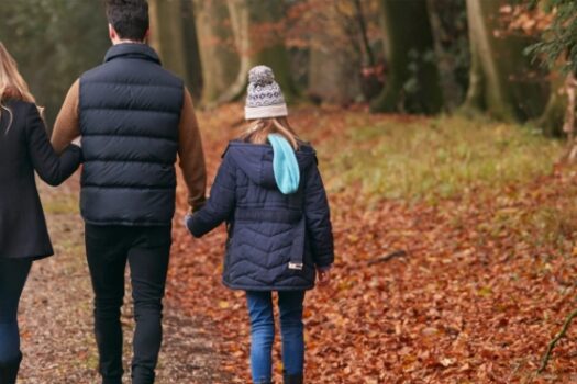 family walking through the woods