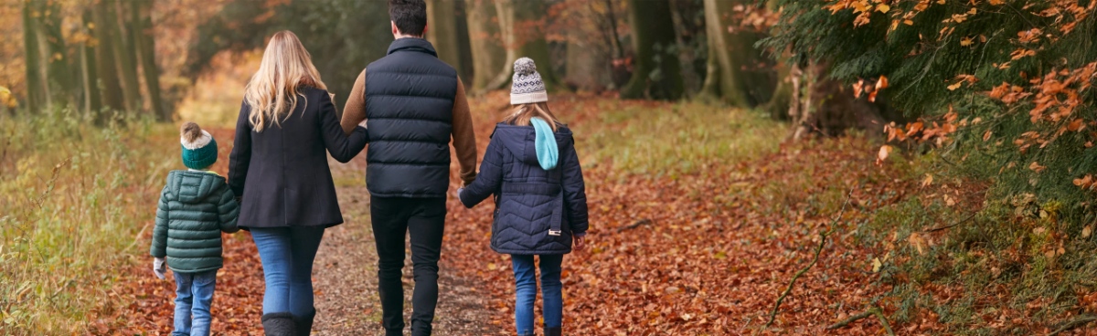 family walking through the woods